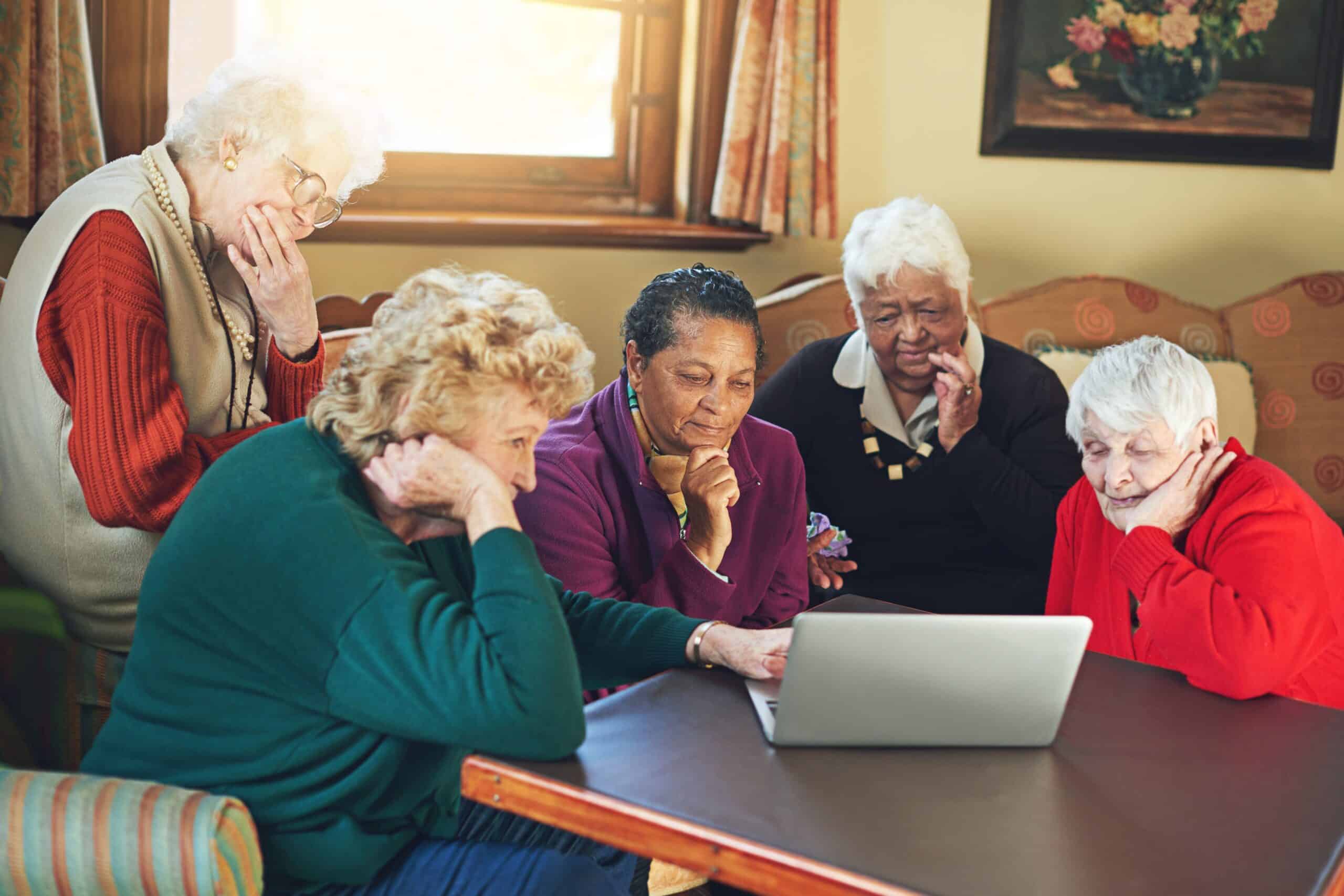Senior women engaged in using a laptop